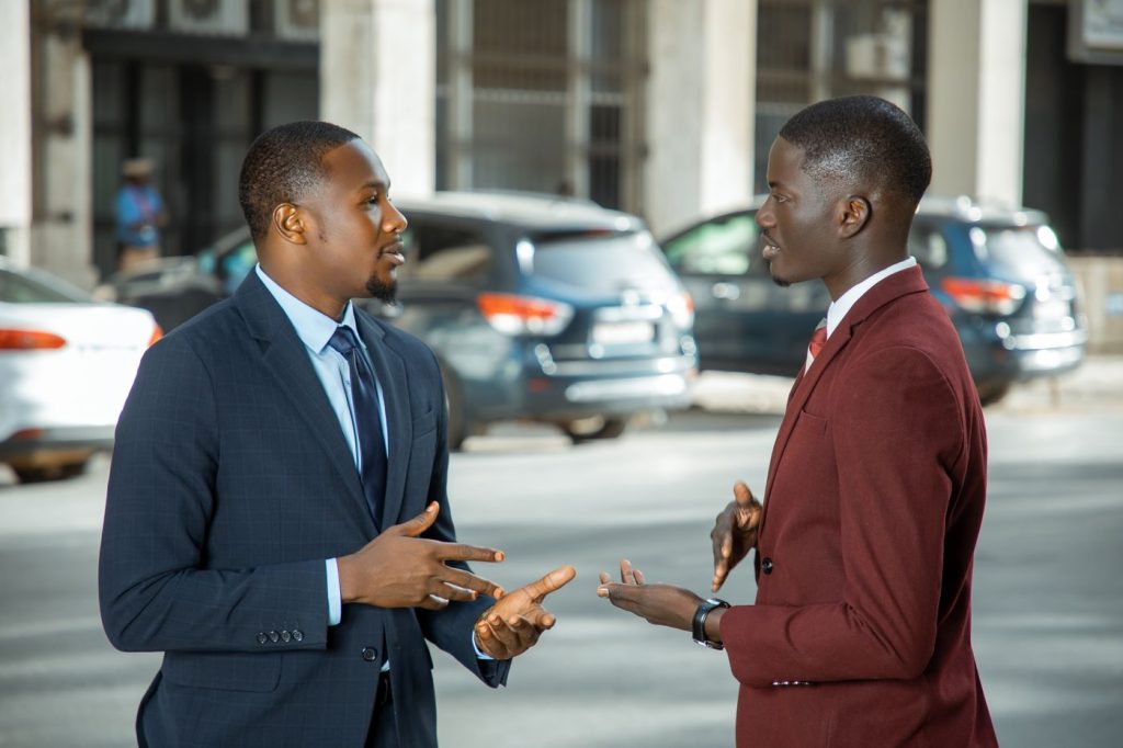 Two business leaders in suits in conversation
